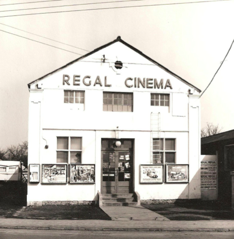 The Regal Cinema in 1964. The central and right hand first floor windows were the projection room. The iron ladder under the top right window was the fire escape from the projection room. The stairs to the balcony were behind the left hand windows and there was a small box office behind the win- dow to the right of the doors.