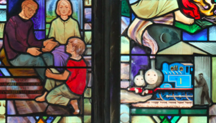 Part of the memorial window at St Mary Magdelene, Rodborough with Thomas the tank engine at bottom right.