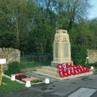 The newly cleaned war memorial on Remembrance Day. Little wooden crosses on either side of the Memorial represent those who died in the First World War.