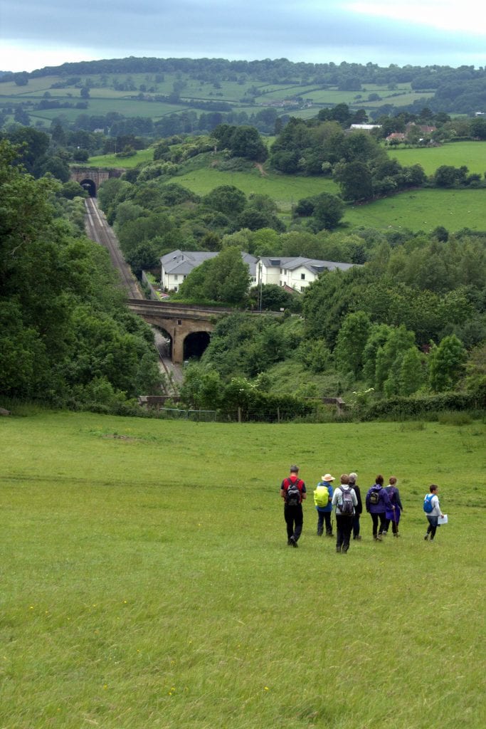 Walking group approaching the top of the Box Tunnel with Middlehill Tunnel in the distance
