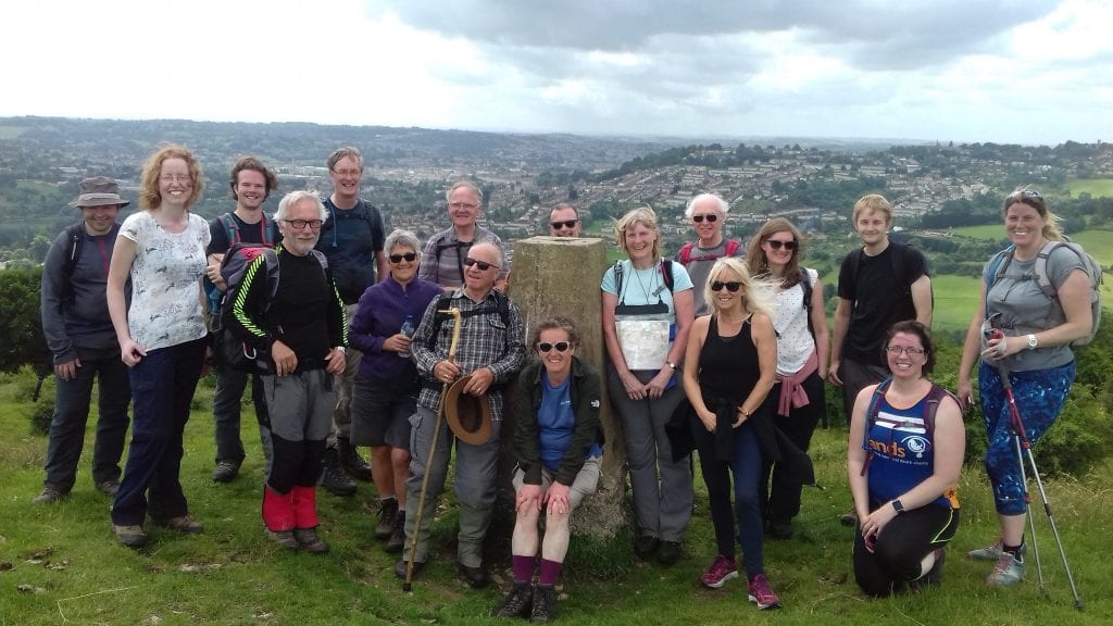 Walkers at the top of Solsbury Hill on one of our long distance walks of 20 miles