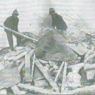 Firemen searching the wreckage of the pub gas explosion